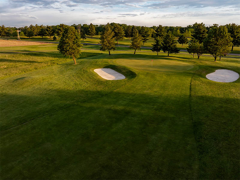 Hole 11 overlooking the 2 sand bunkers while the sun is setting on the Flatbush golf course.